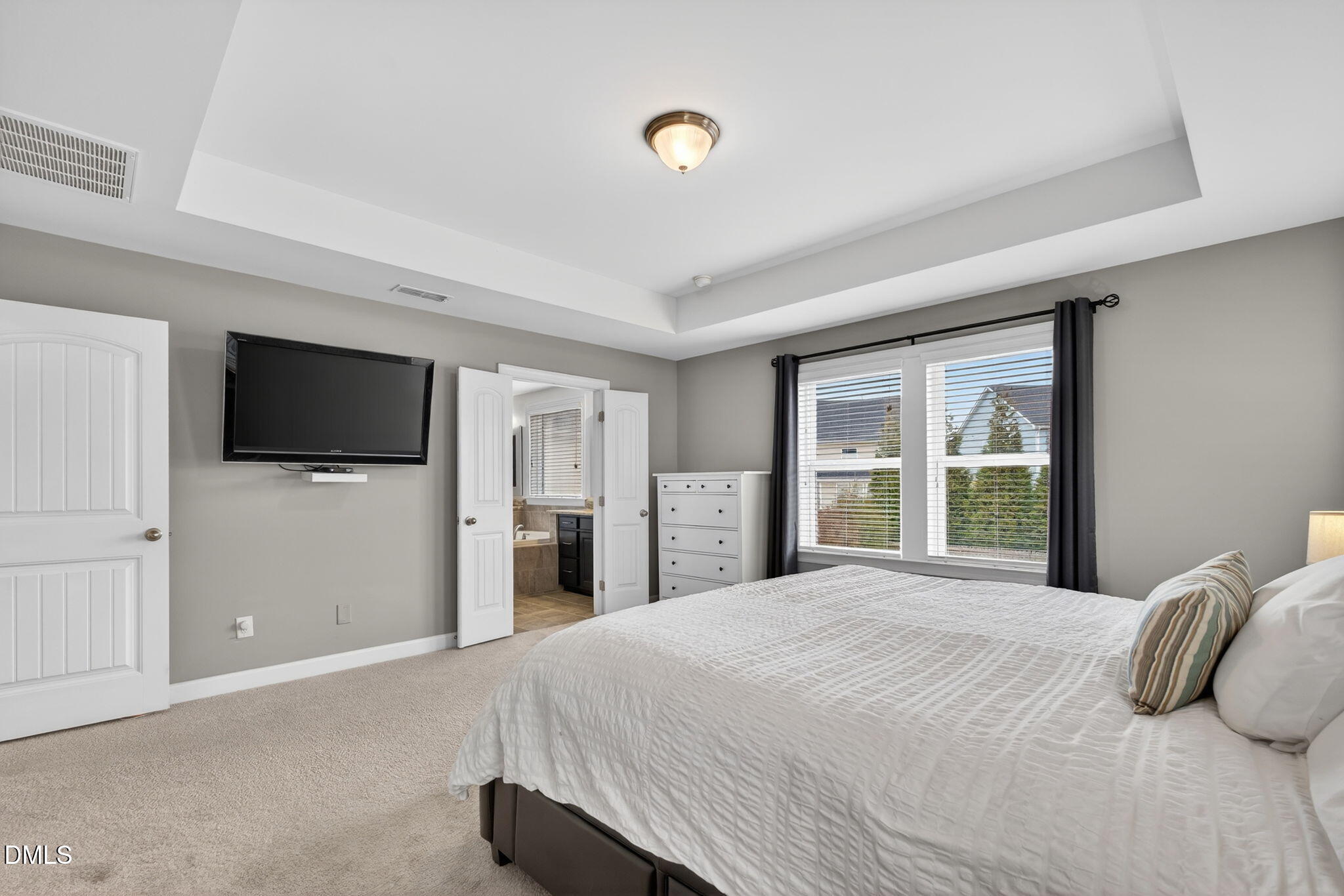 8001 Hergety Drive Raleigh, NC 27603 - Photo 26 of 52 a bedroom with a bed and a flat screen tv