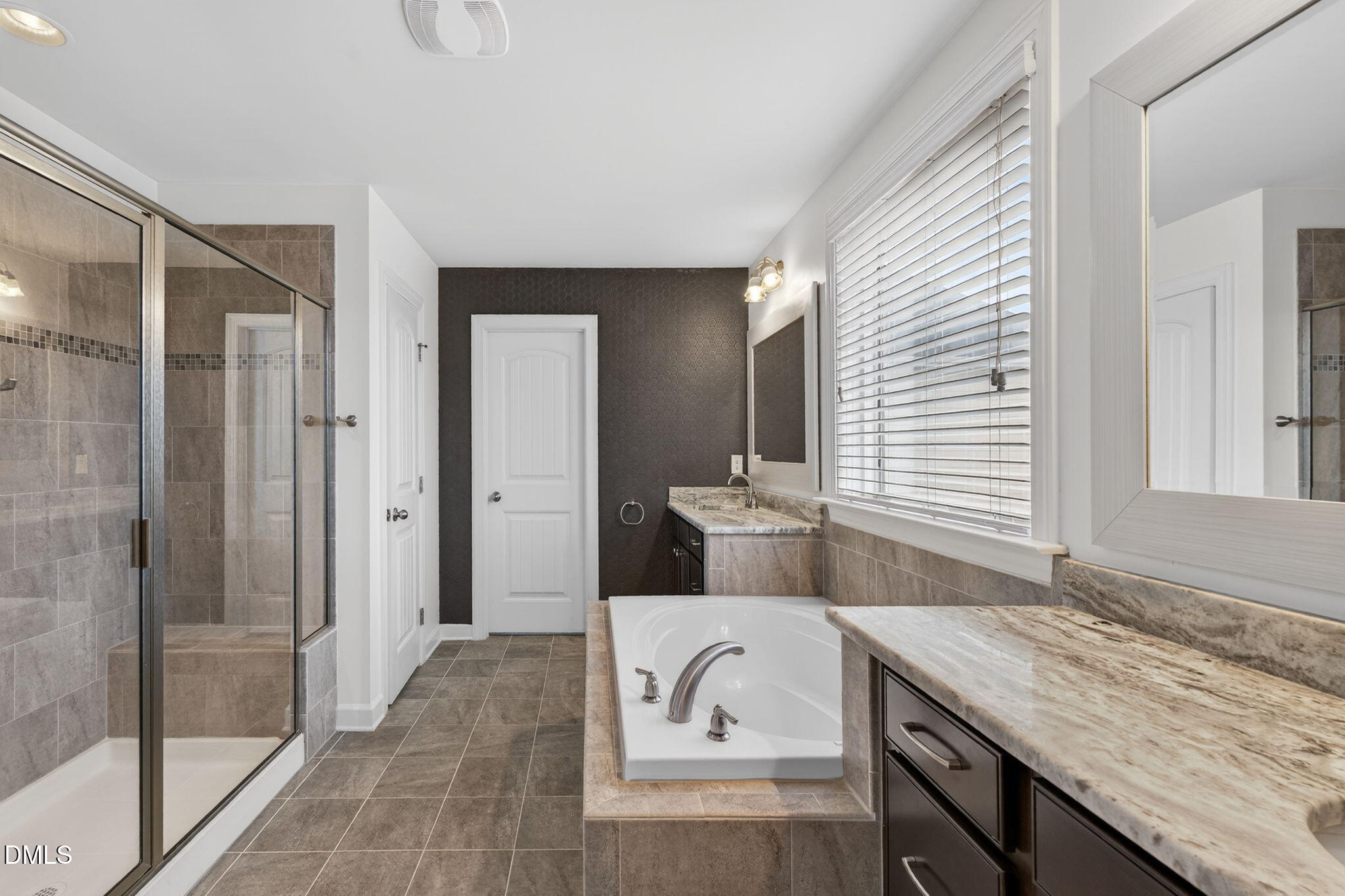 8001 Hergety Drive Raleigh, NC 27603 - Photo 28 of 52 a bathroom with a granite countertop sink and a mirror