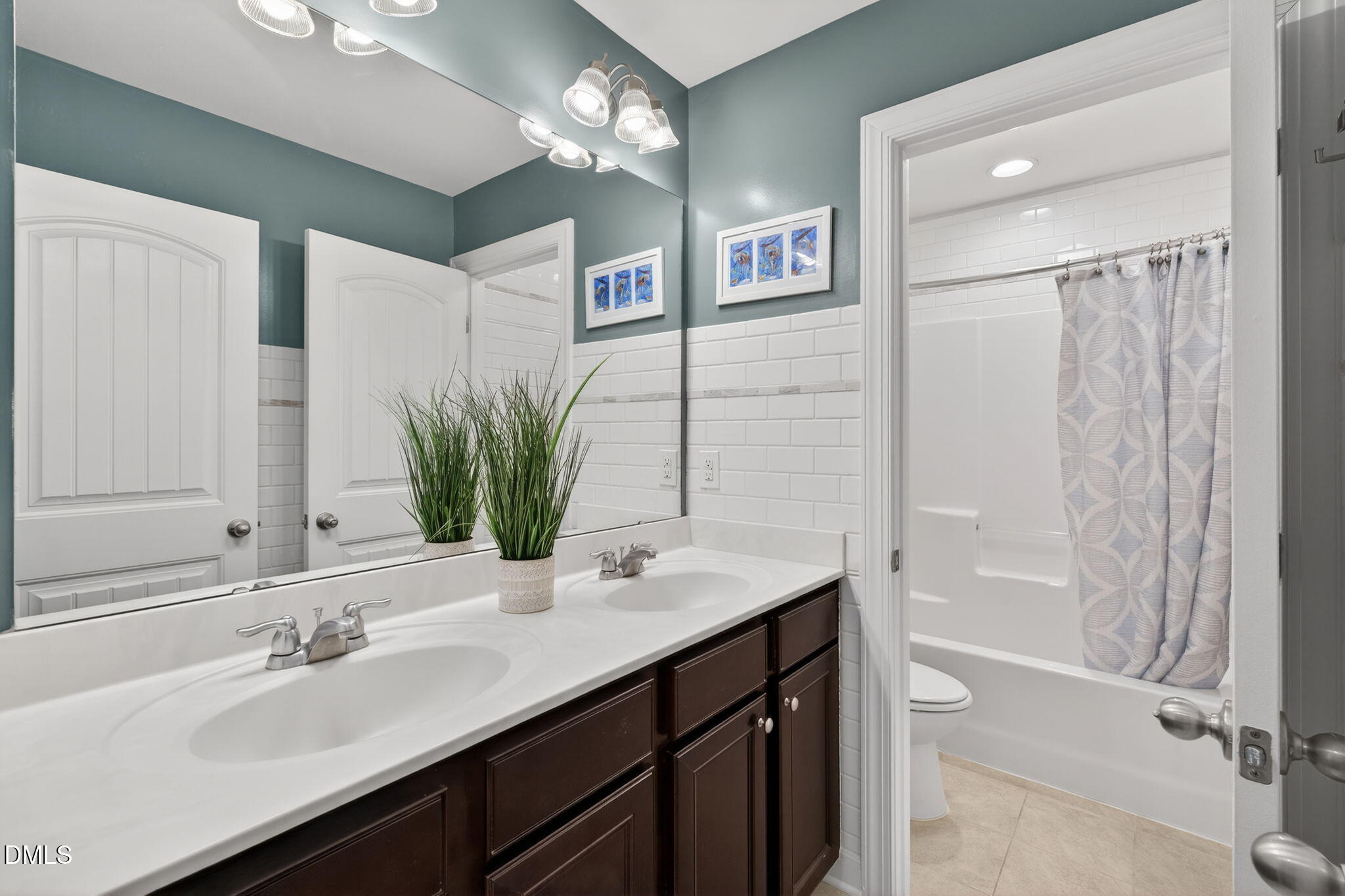 8001 Hergety Drive Raleigh, NC 27603 - Photo 40 of 52 a bathroom with a sink a bathtub and a mirror