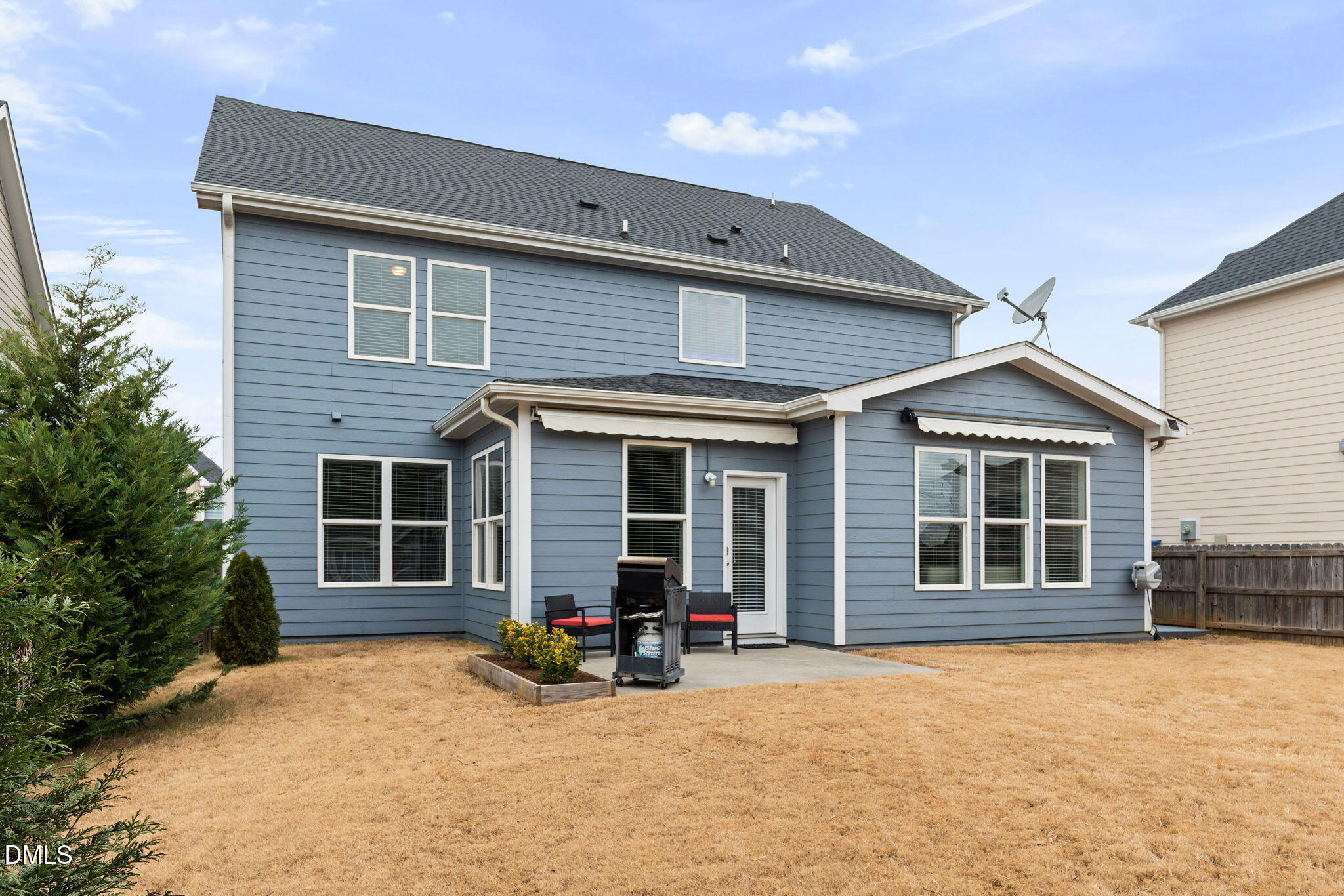 8001 Hergety Drive Raleigh, NC 27603 - Photo 45 of 52 a view of a house with large windows and a large tree