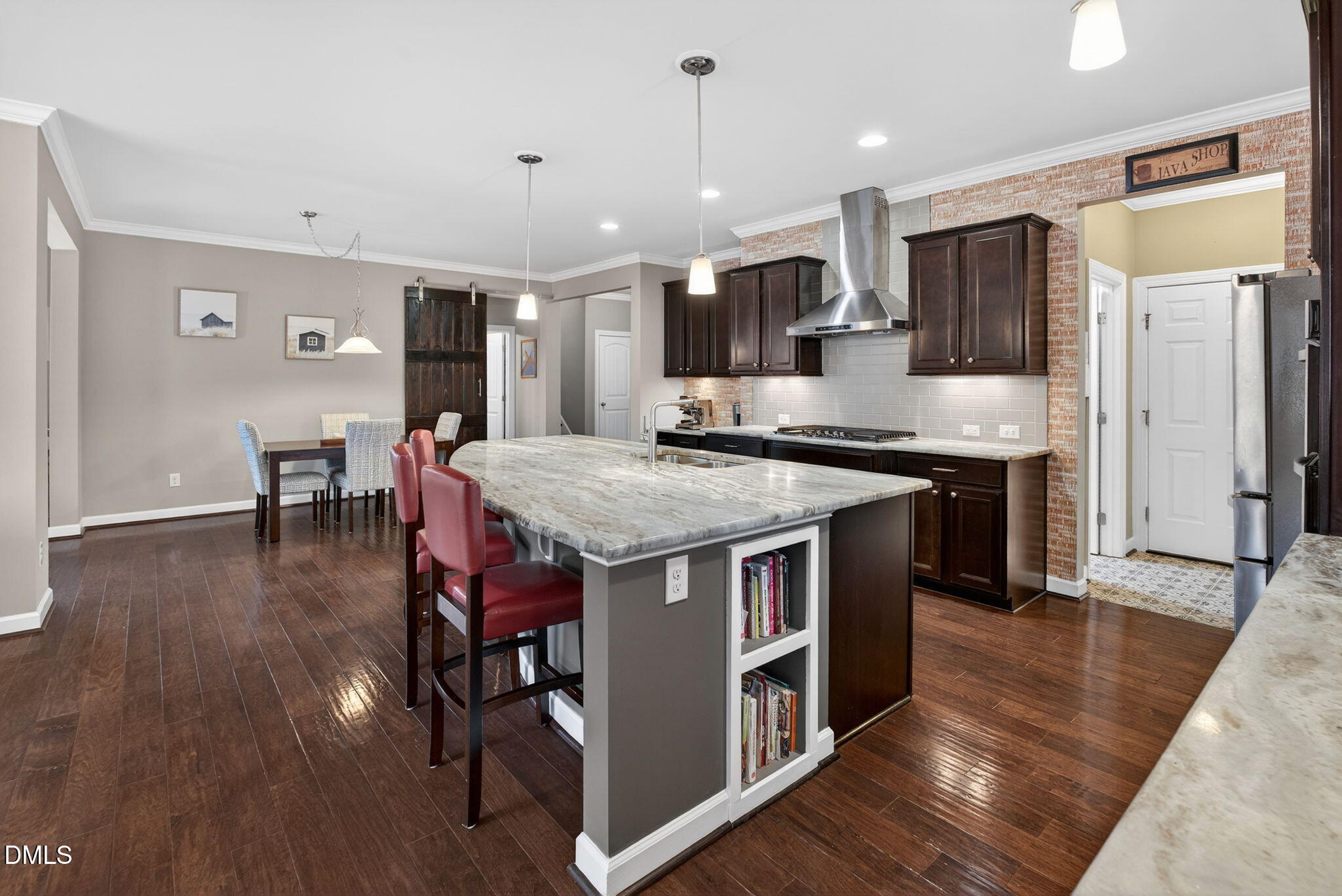 8001 Hergety Drive Raleigh, NC 27603 - Photo 5 of 52 a kitchen with stainless steel appliances granite countertop a kitchen island a stove and a wooden floors