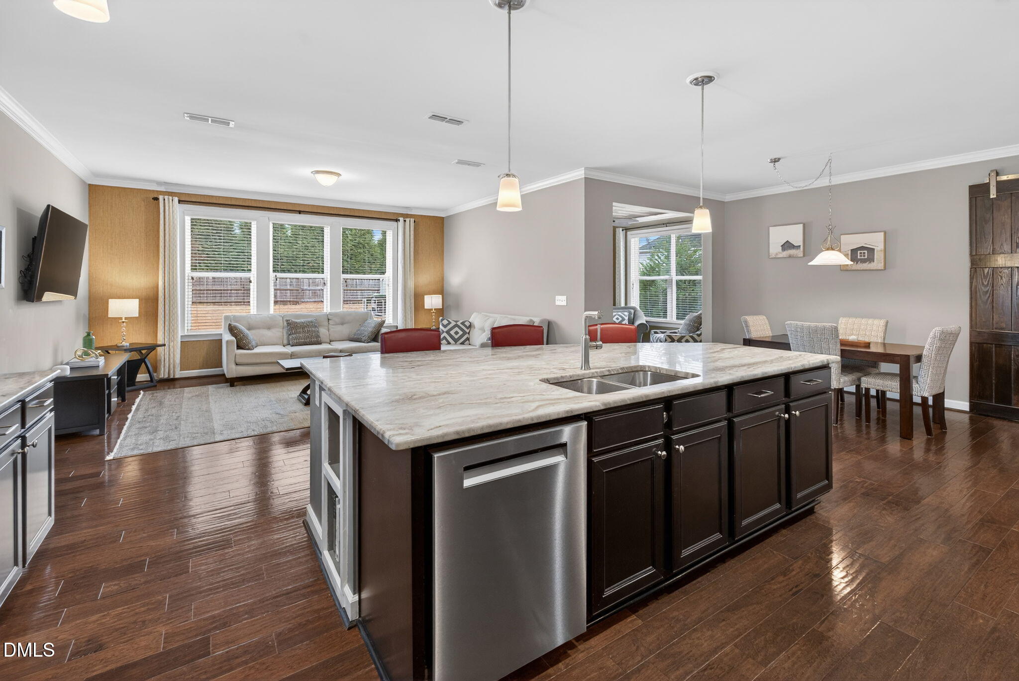 8001 Hergety Drive Raleigh, NC 27603 - Photo 7 of 52 a open kitchen with a large center island wooden floor and living room view