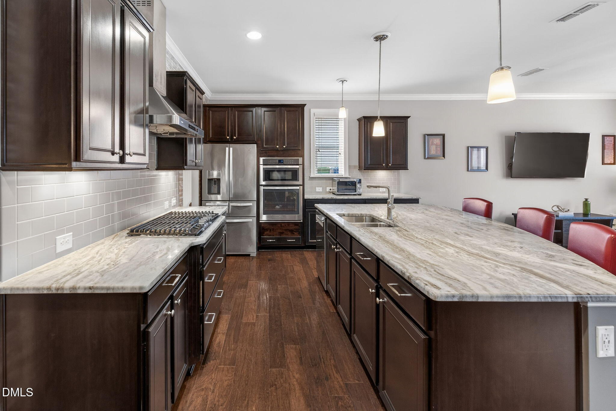 8001 Hergety Drive Raleigh, NC 27603 - Photo 8 of 52 a open kitchen with stainless steel appliances granite countertop a kitchen island a stove and a sink