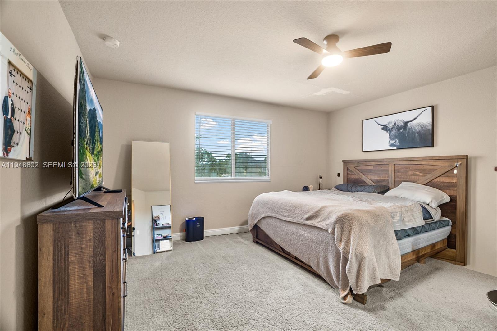 5951 Royal Way Tamarac, FL 33321 - Photo 12 of 33 a bedroom with a bed flat screen tv and a window