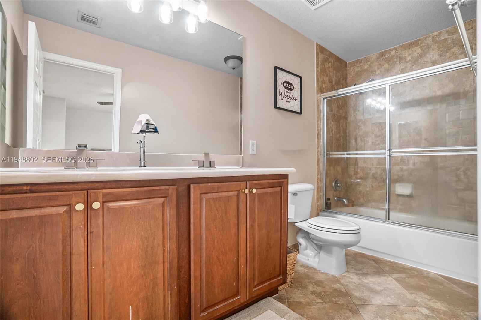 5951 Royal Way Tamarac, FL 33321 - Photo 14 of 33 a bathroom with a sink toilet a mirror and shower