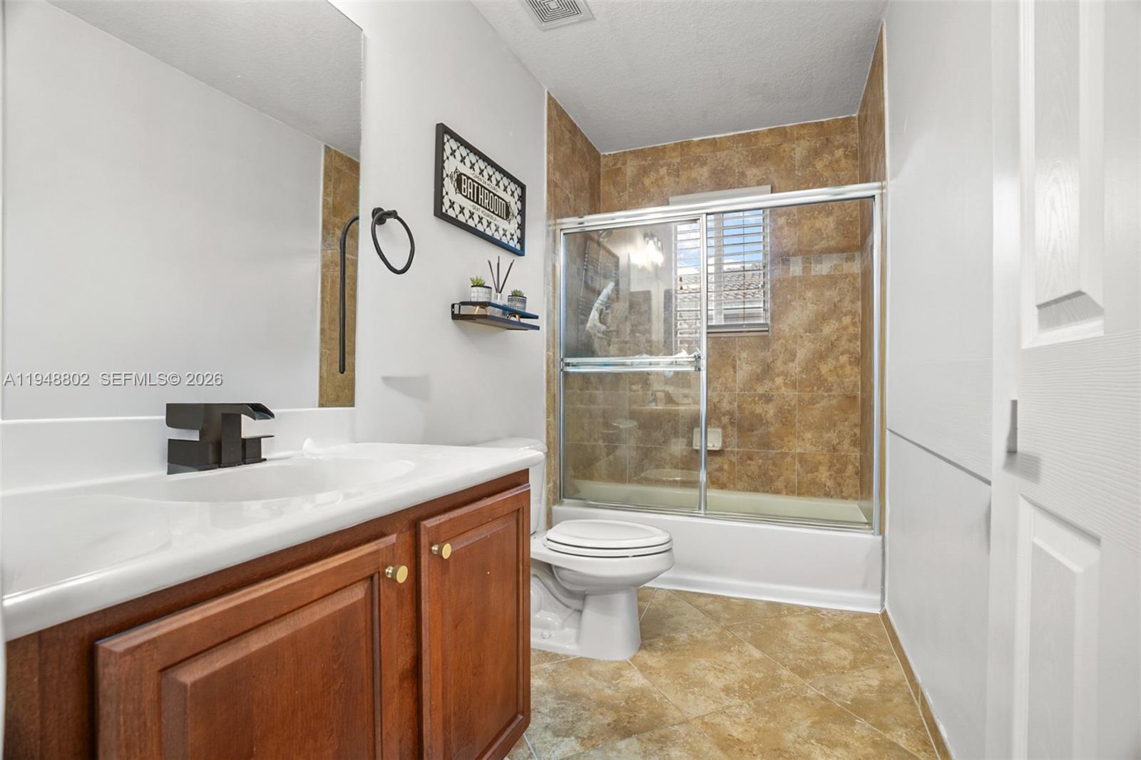 5951 Royal Way Tamarac, FL 33321 - Photo 18 of 33 a bathroom with a sink a toilet and shower