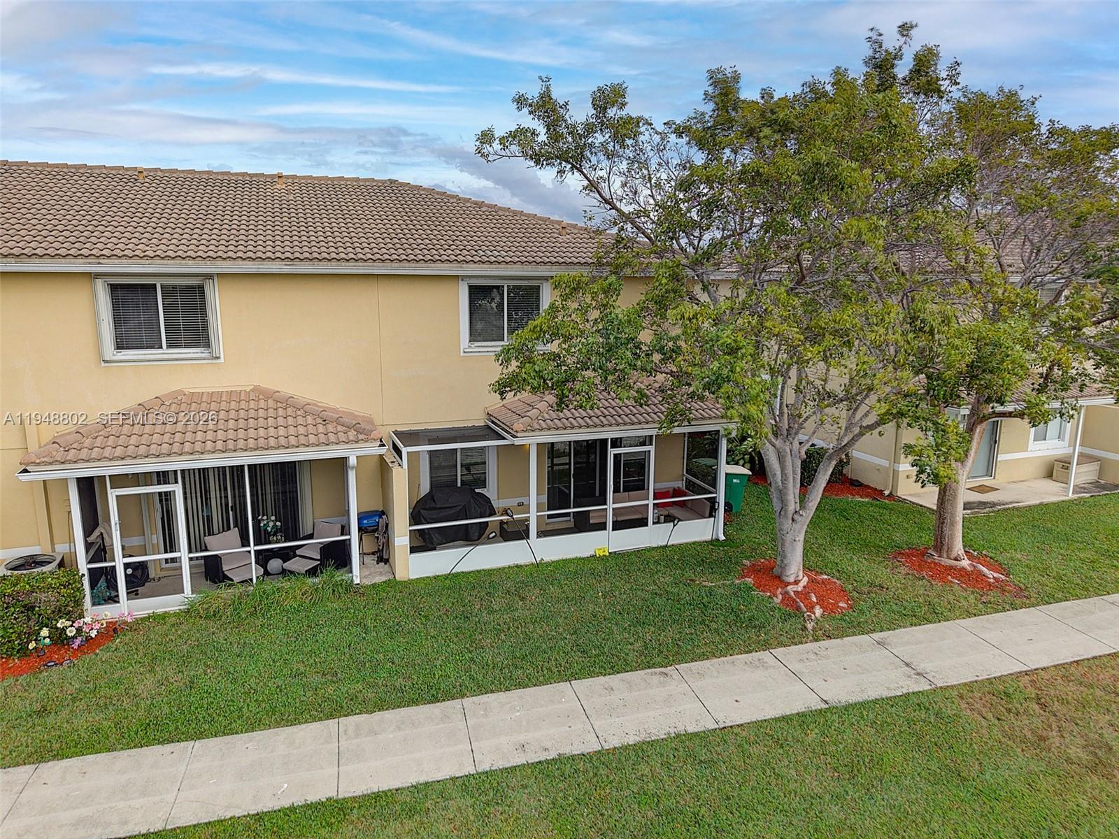 5951 Royal Way Tamarac, FL 33321 - Photo 22 of 33 a front view of a house with a yard and trees