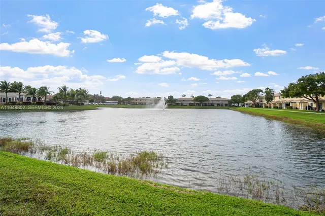 a view of a lake with houses in the back
