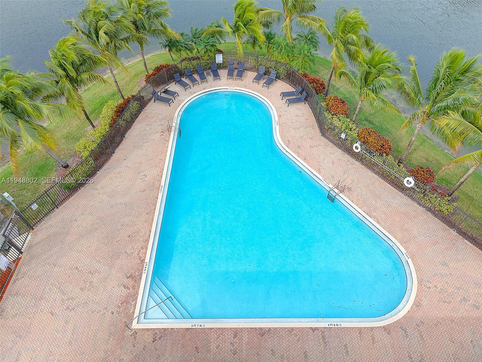 5951 Royal Way Tamarac, FL 33321 - Photo 24 of 33 a view of swimming pool with a garden