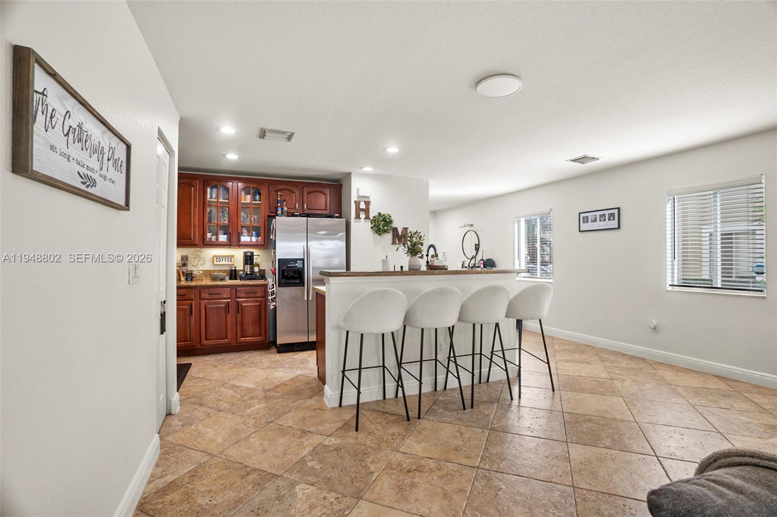 5951 Royal Way Tamarac, FL 33321 - Photo 4 of 33 a kitchen with kitchen island granite countertop lots of white cabinets a sink and stainless steel appliances