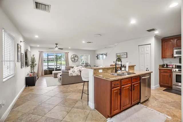a view of kitchen with kitchen island and living room