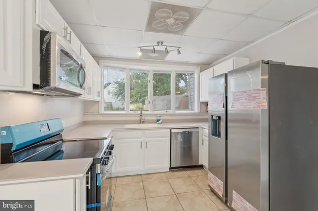a view of backyard with seating space and trees
