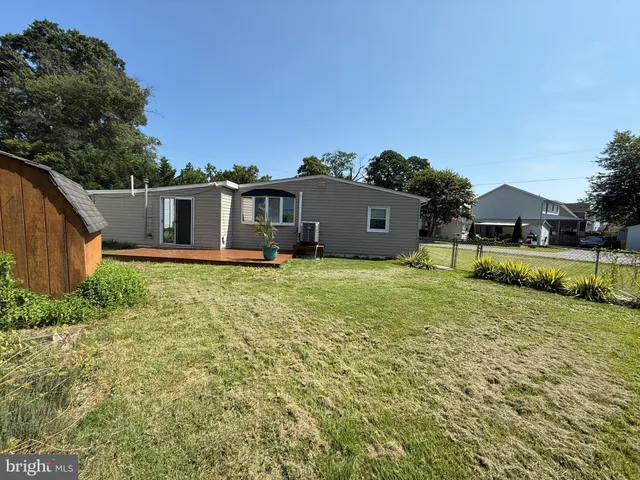 a view of house with garden and swimming pool