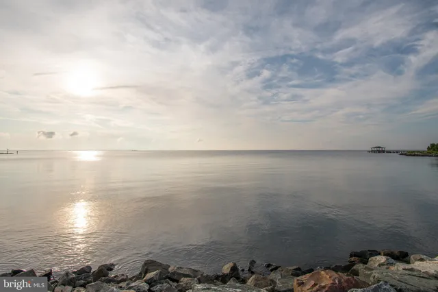 a front view of a house with a yard table and chairs