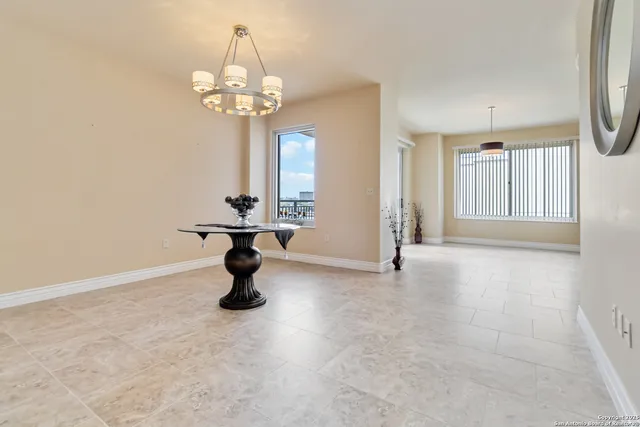 a spacious bedroom with a bed and a large window