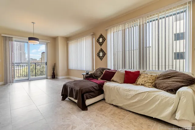 a spacious bedroom with a bed and a large window