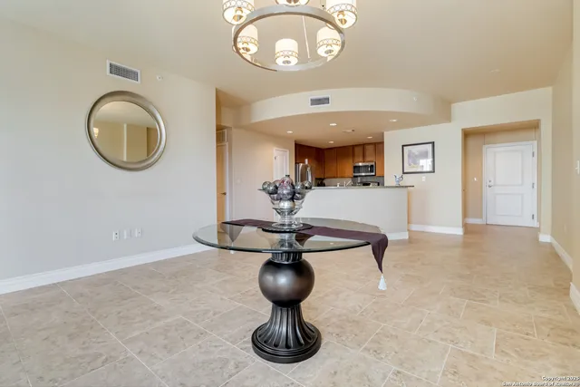 a view of living room filled with furniture and a chandelier