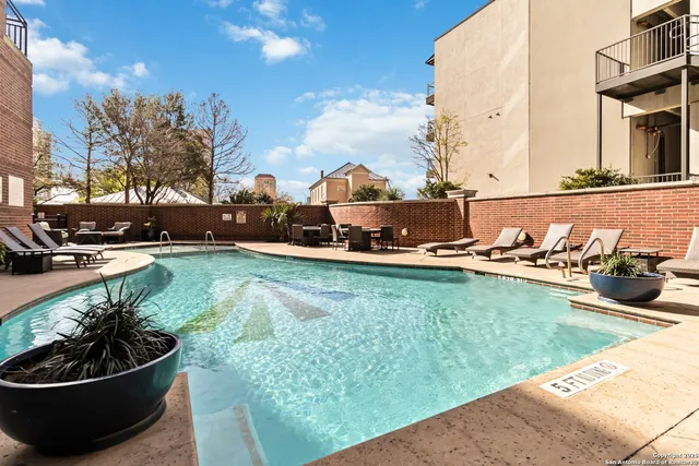 a view of a patio with table and chairs and potted plants