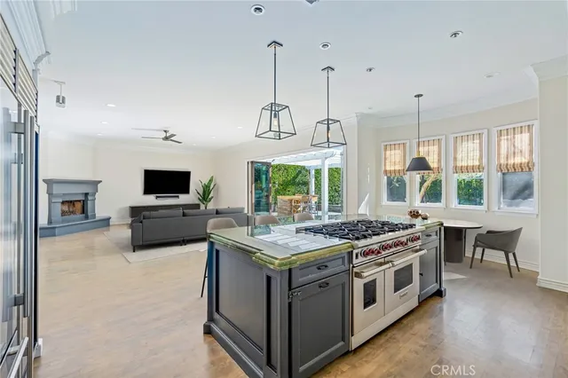 a kitchen with a stove and a flat screen tv
