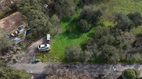 an aerial view of a house with a yard