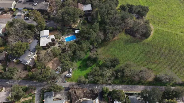 an aerial view of a house with a yard