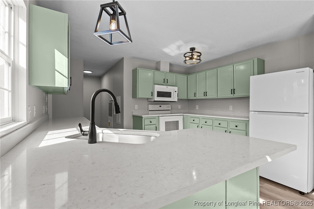 670 Bear Bay Road Lumberton, NC 28358 - Photo 3 of 25 a kitchen with a refrigerator and a sink