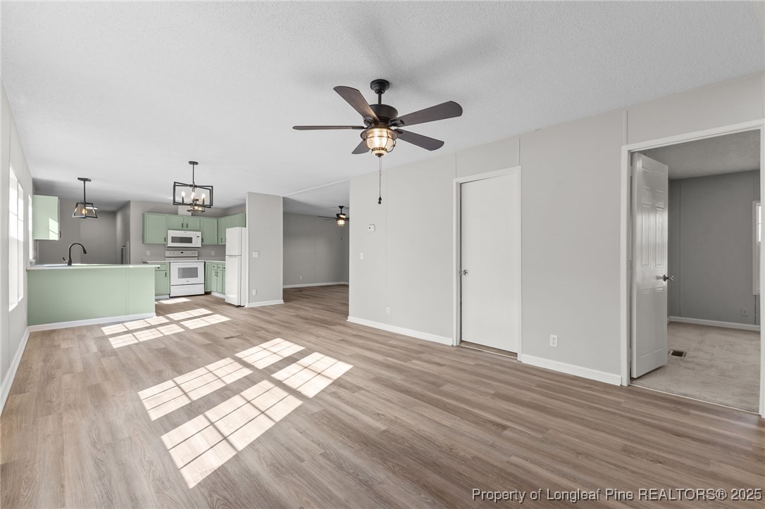 670 Bear Bay Road Lumberton, NC 28358 - Photo 6 of 25 a view of a kitchen with wooden floor and a kitchen space