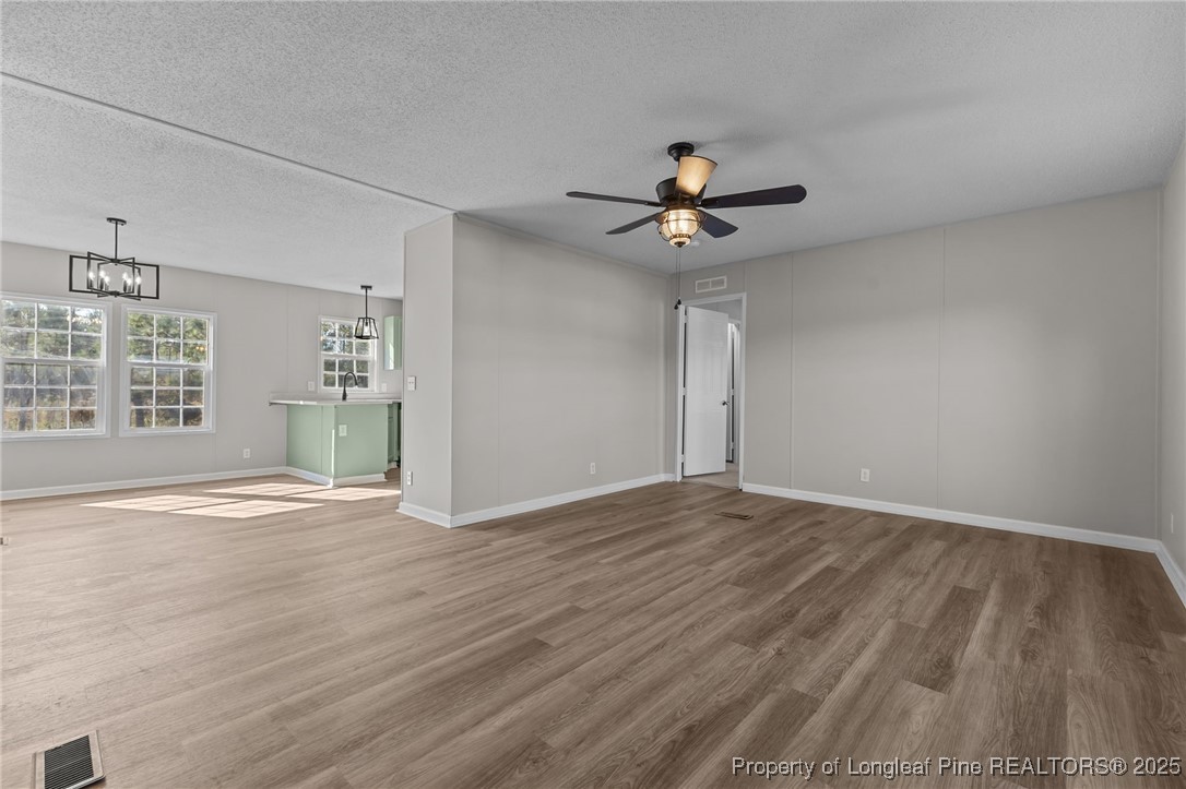 670 Bear Bay Road Lumberton, NC 28358 - Photo 8 of 25 a view of an empty room with a window and wooden floor