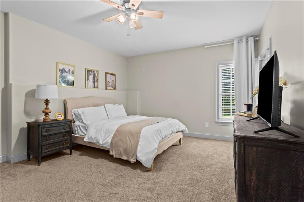 2630 Old Atlanta Road Cumming, GA 30041 - Photo 51 of 87 a spacious bedroom with a bed and a flat screen tv