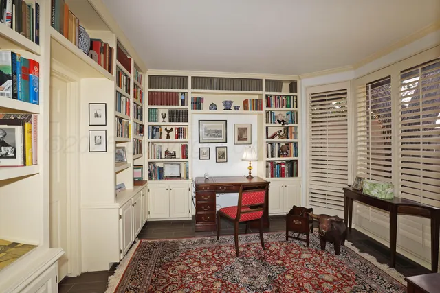 a room that has a bookshelf and a chair in it
