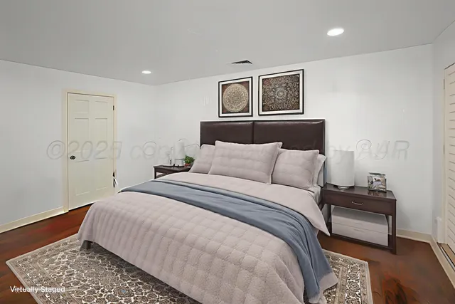 a bedroom with a bed and a lamp