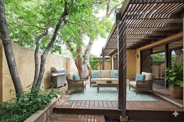 a view of balcony with furniture and garden