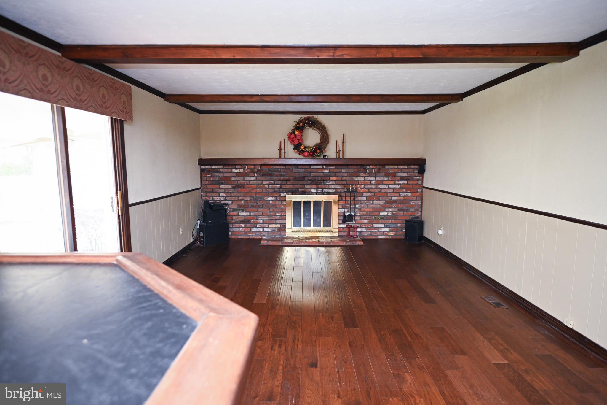 1713 Red Oak Road Williamstown, NJ 08094 - Photo 21 of 76 a view of an empty room with wooden floor fireplace and a window