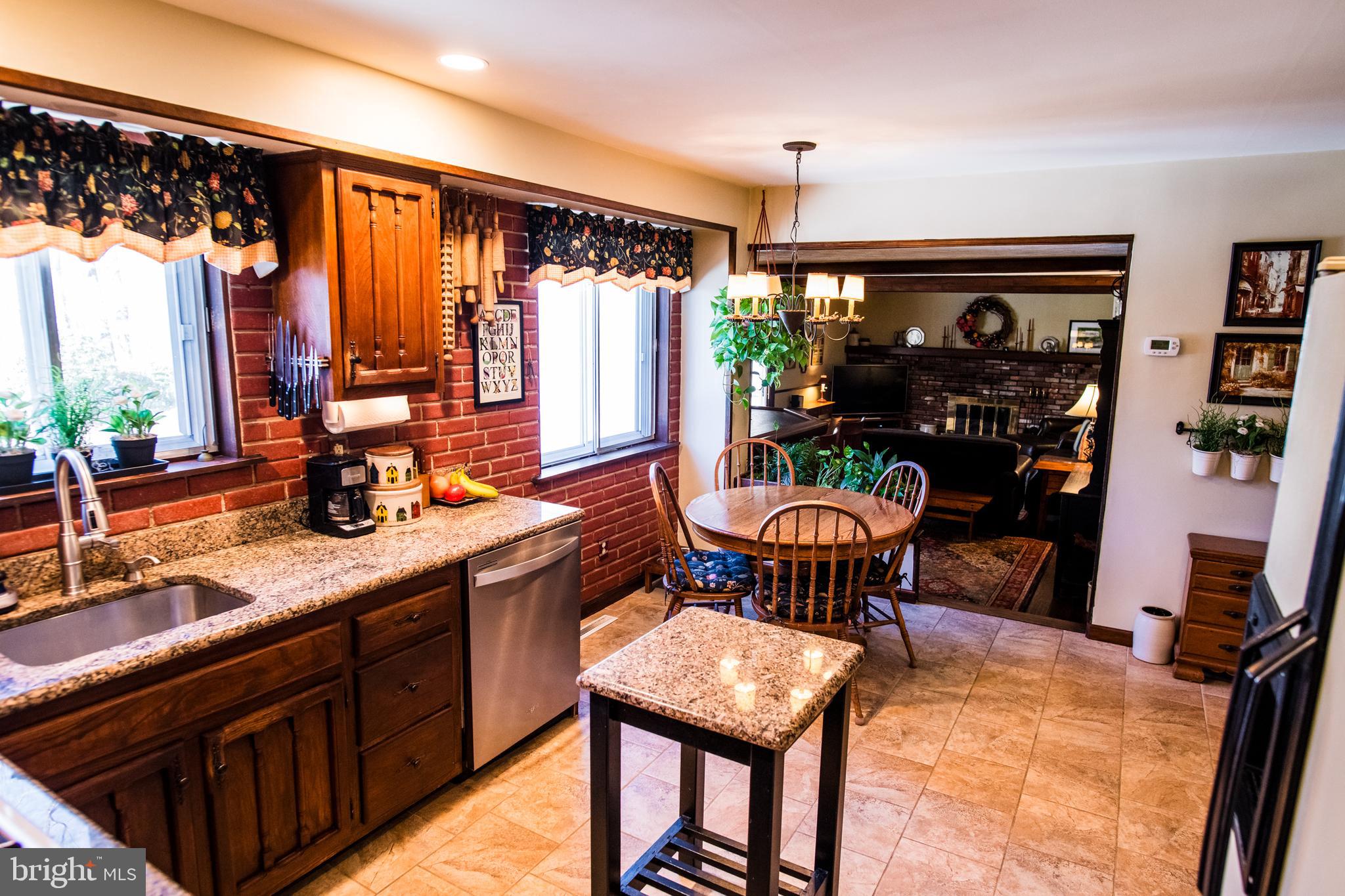 1713 Red Oak Road Williamstown, NJ 08094 - Photo 29 of 76 a kitchen with stainless steel appliances granite countertop sink stove top oven table and chairs