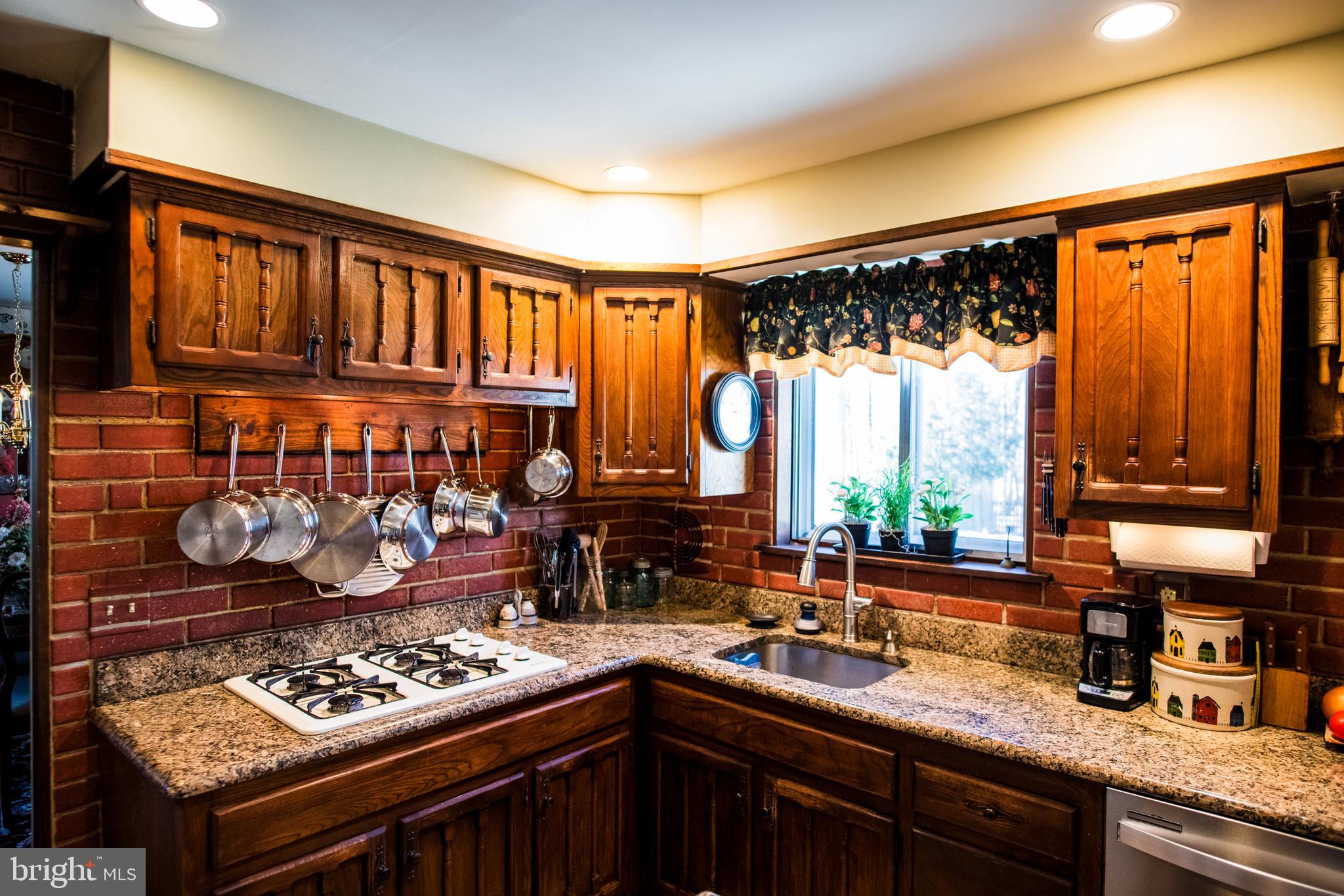 1713 Red Oak Road Williamstown, NJ 08094 - Photo 32 of 76 a kitchen with stainless steel appliances granite countertop a sink stove and cabinets