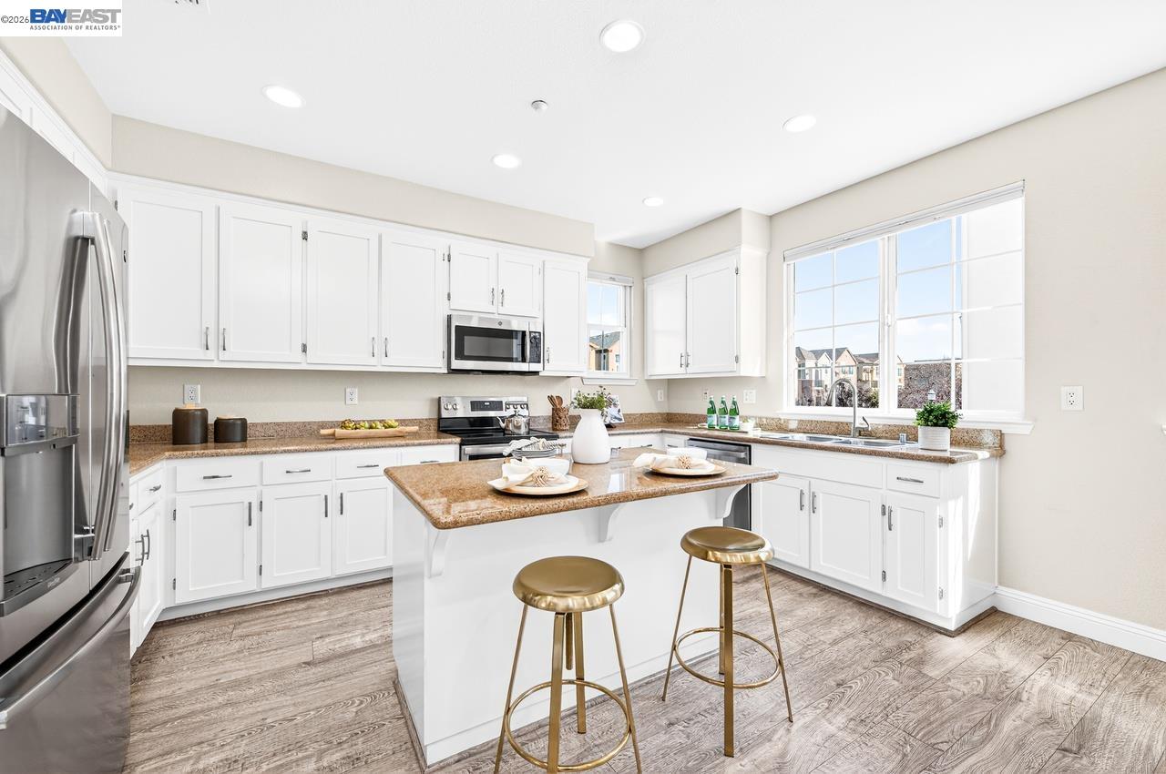 2871 First Street, Unit 901 Livermore, CA 94550 - Photo 13 of 46 a kitchen with white cabinets stove and refrigerator