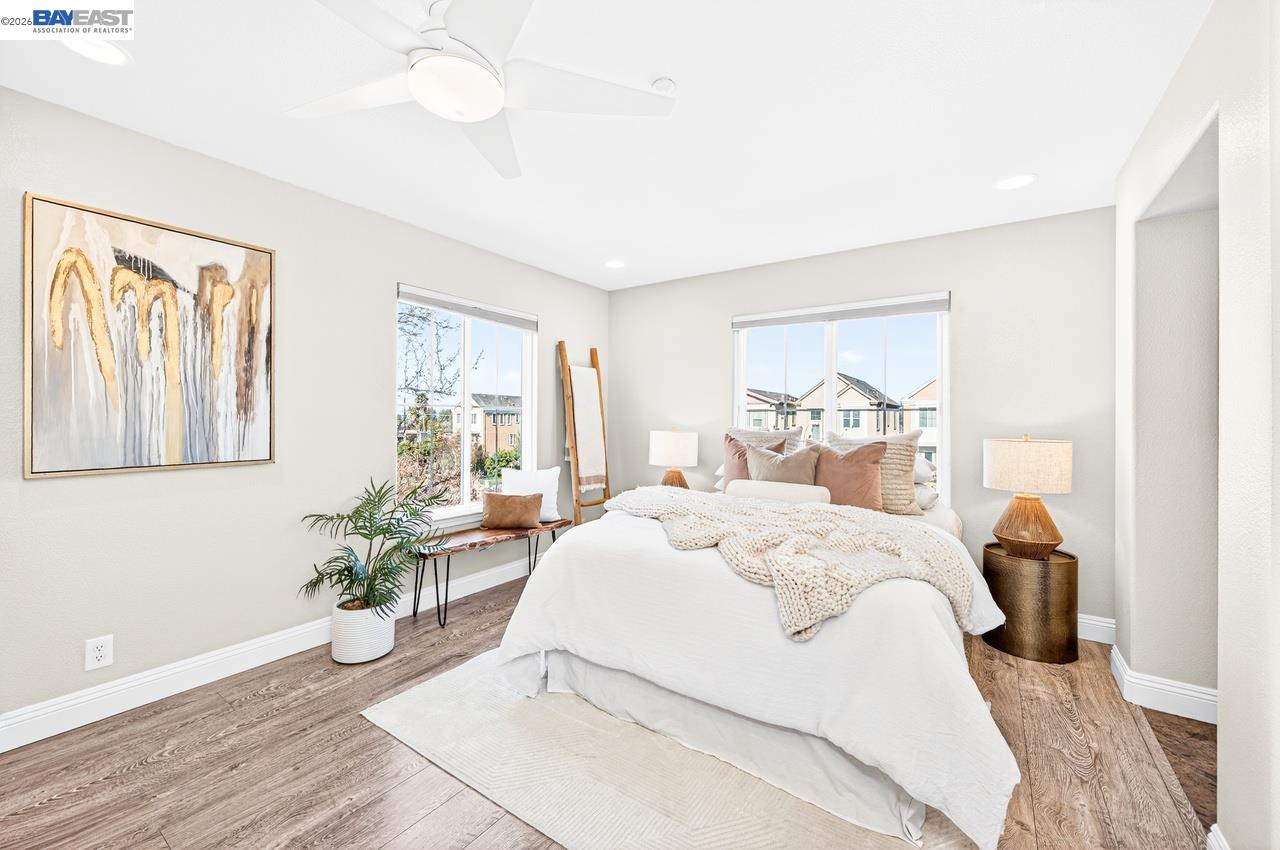 2871 First Street, Unit 901 Livermore, CA 94550 - Photo 23 of 46 a bedroom with a large bed and a chandelier