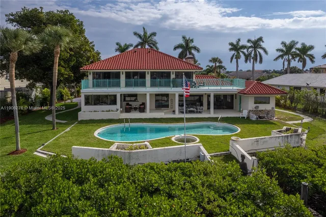 an aerial view of a house with a swimming pool