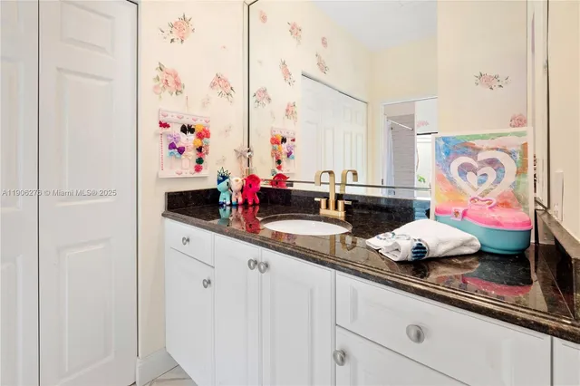 a bathroom with sink and mirror
