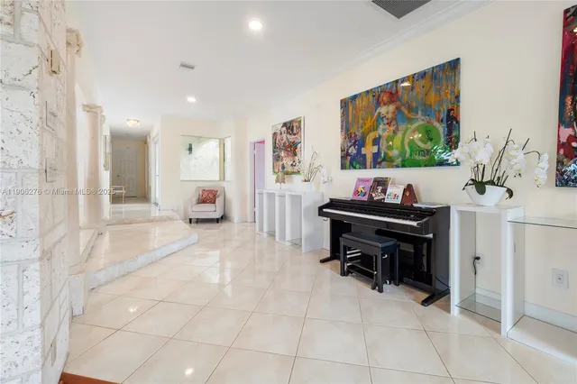 a view of a workspace with furniture and a flat screen tv