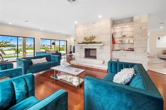 a living room with furniture fireplace and a view of kitchen