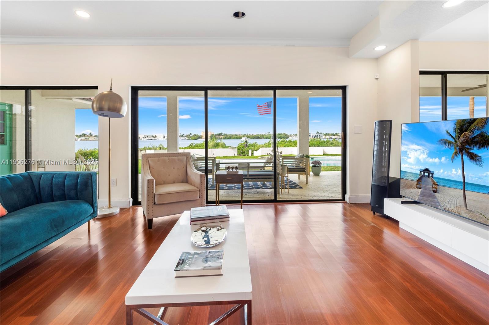 1635 Lands End Road Manalapan, FL 33462 - Photo 27 of 38 a living room with furniture large window and wooden floor