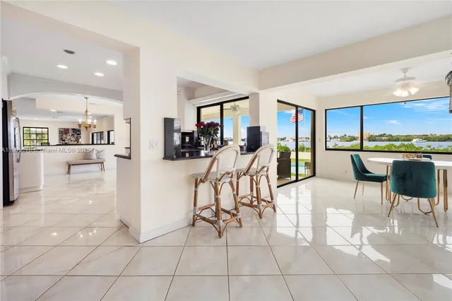 a kitchen with stainless steel appliances kitchen island granite countertop a refrigerator and a sink
