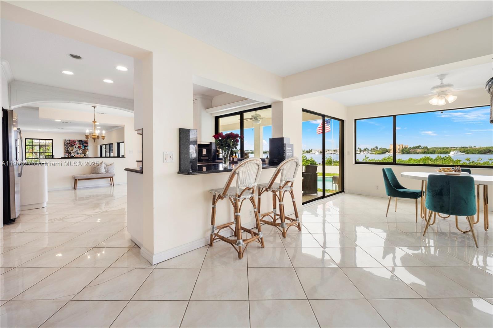 1635 Lands End Road Manalapan, FL 33462 - Photo 36 of 38 a kitchen with stainless steel appliances kitchen island granite countertop a refrigerator and a sink