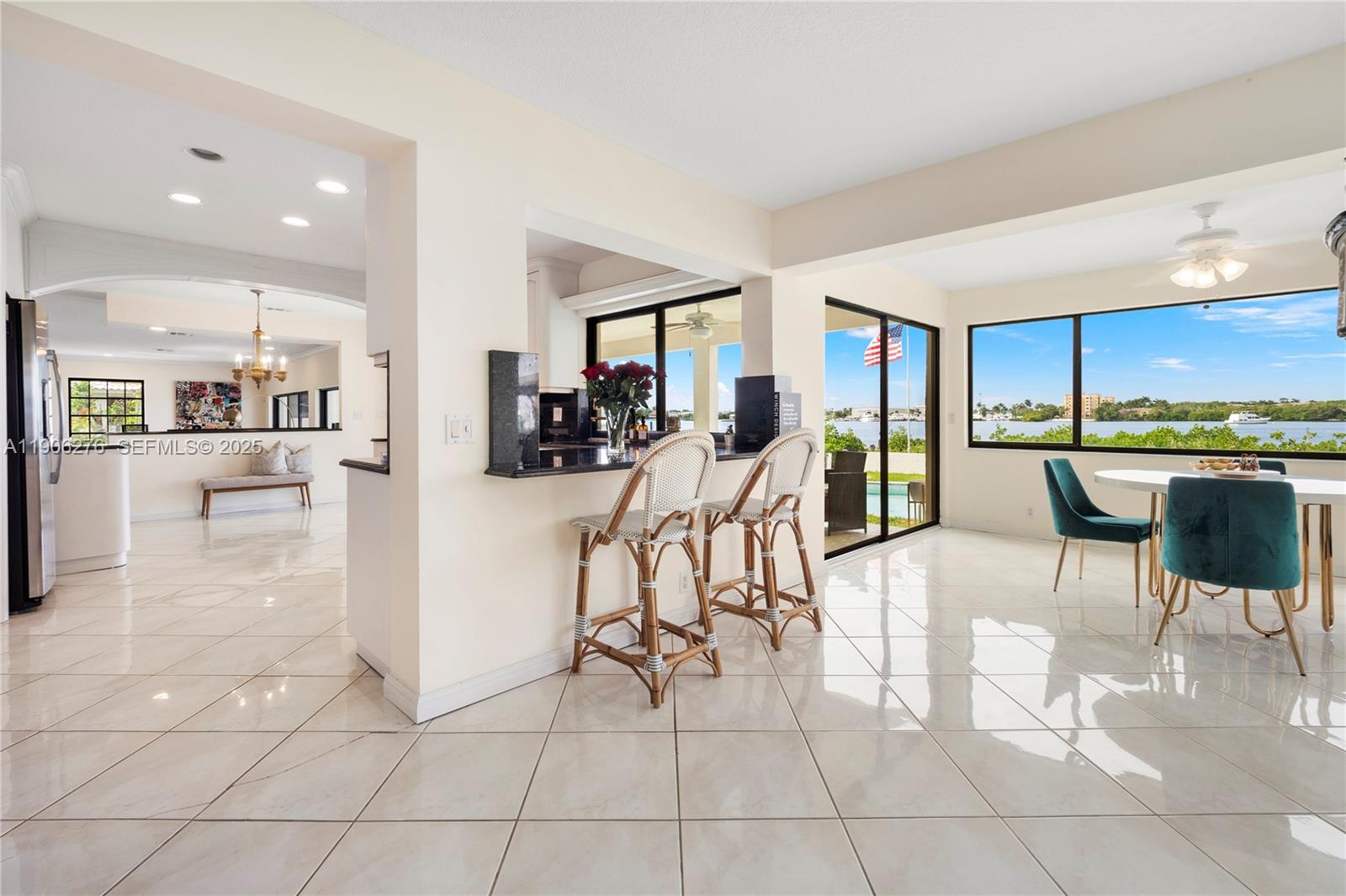 1635 Lands End Road Manalapan, FL 33462 - Photo 36 of 38 a kitchen with stainless steel appliances kitchen island granite countertop a refrigerator and a sink