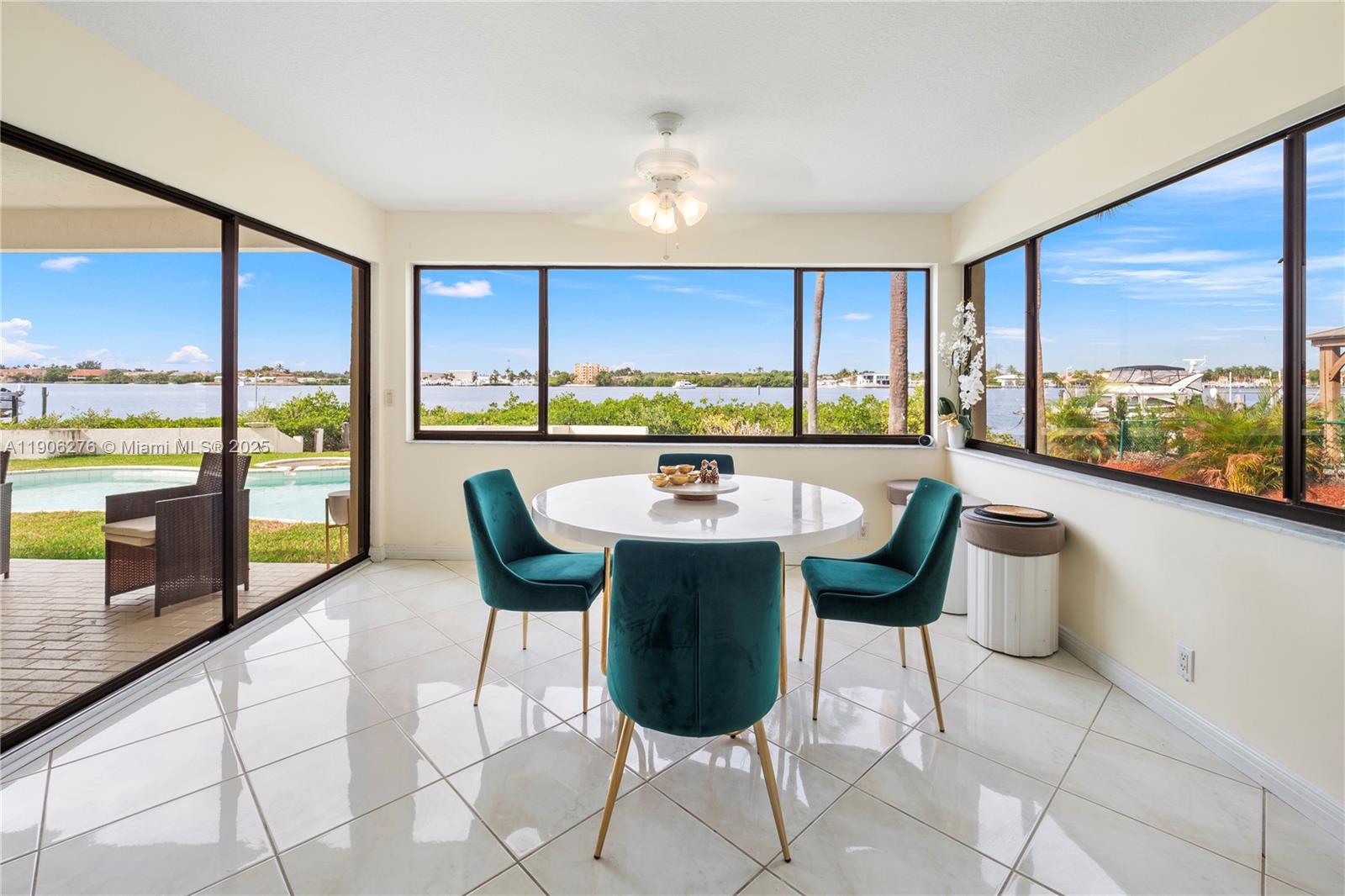 1635 Lands End Road Manalapan, FL 33462 - Photo 37 of 38 a view of a dining room with furniture large windows and wooden floor