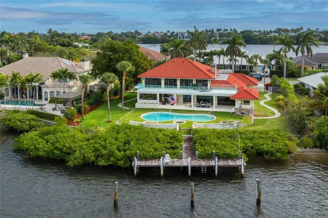 an aerial view of a house with a garden and a yard