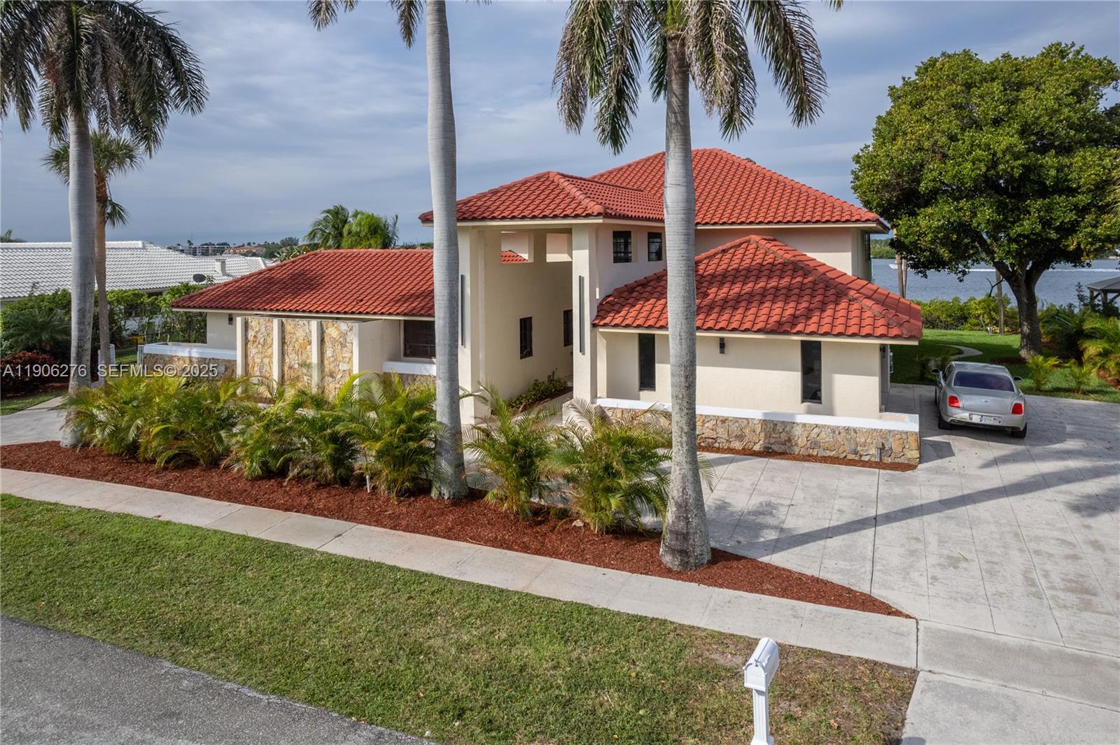 1635 Lands End Road Manalapan, FL 33462 - Photo 8 of 38 a front view of a house with yard and porch