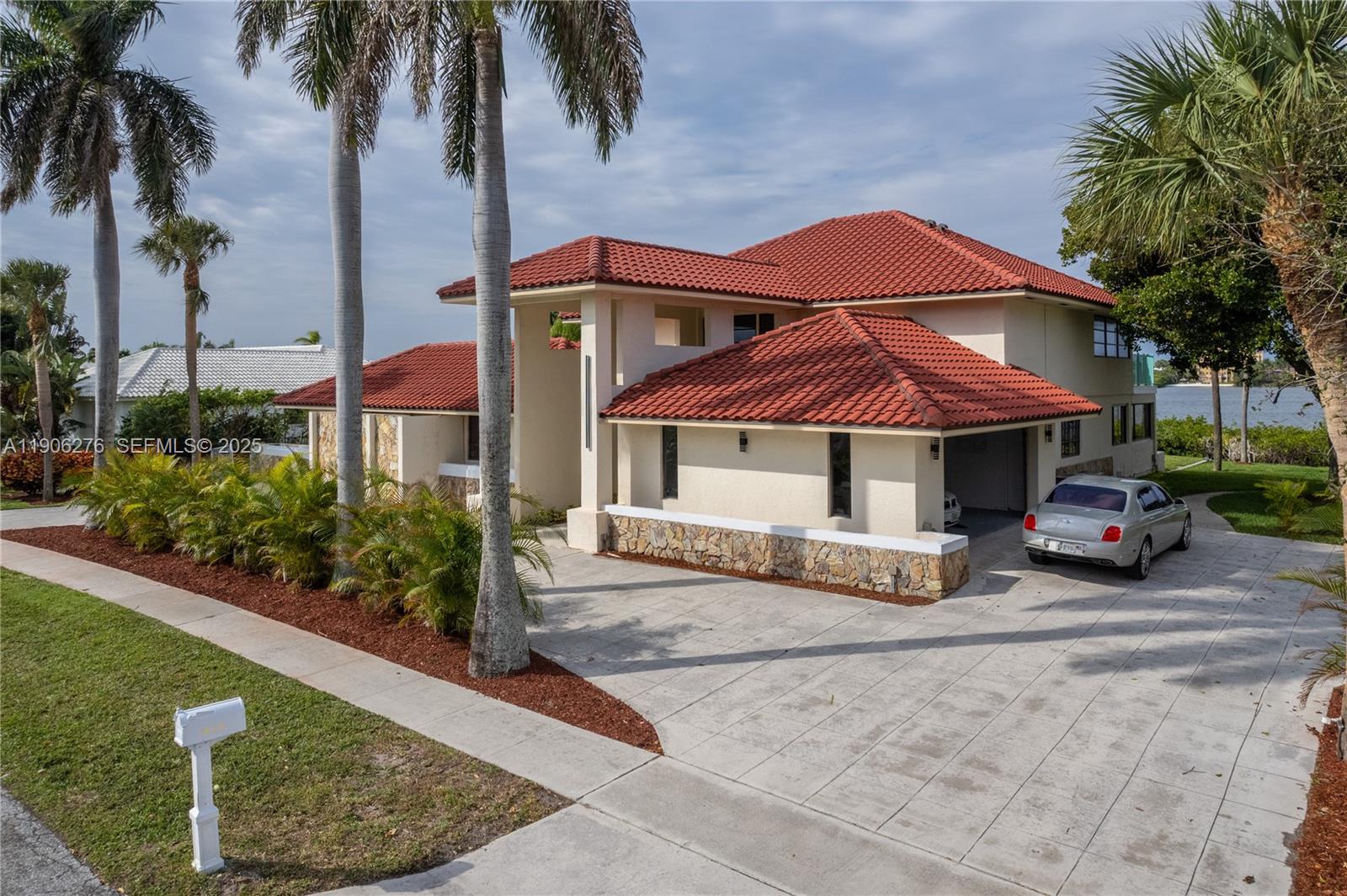 1635 Lands End Road Manalapan, FL 33462 - Photo 9 of 38 a front view of a house with a garden and yard