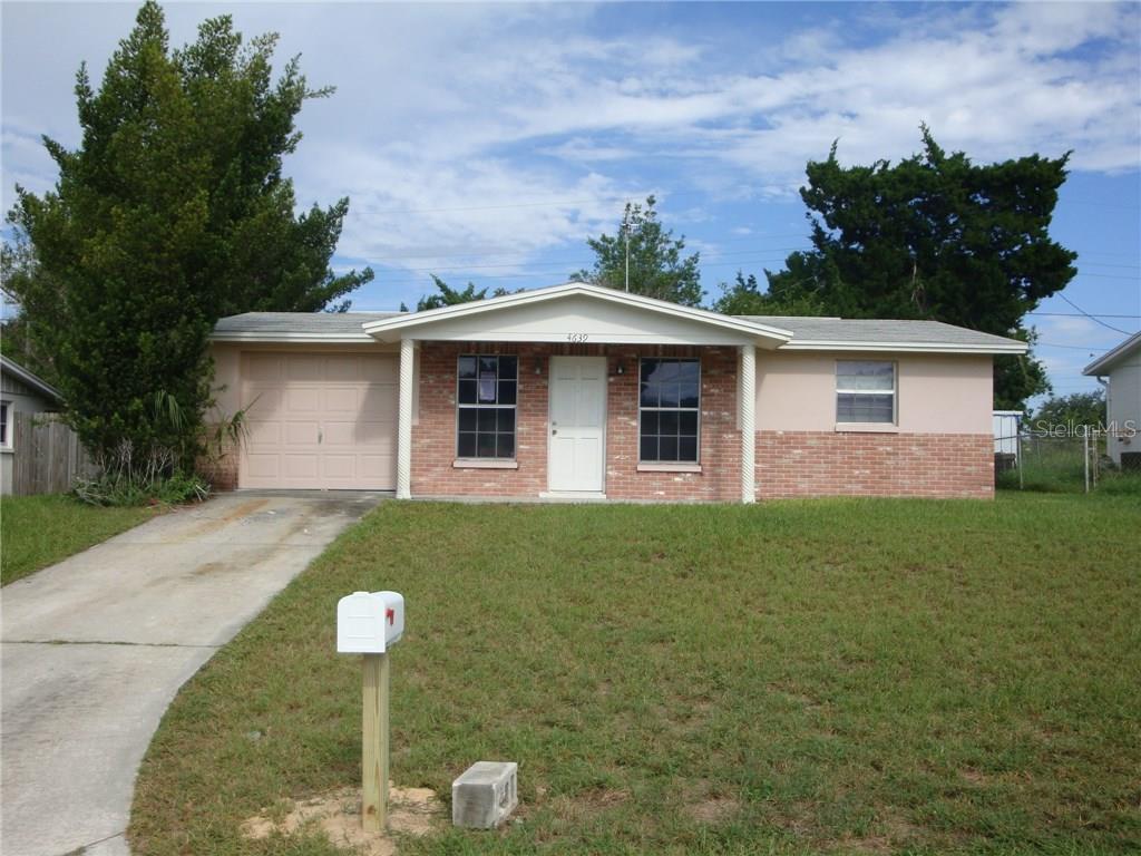 4639 Irene Loop New Port Richey, FL 34652 - Photo 1 of 1 a front view of a house with a yard and garage